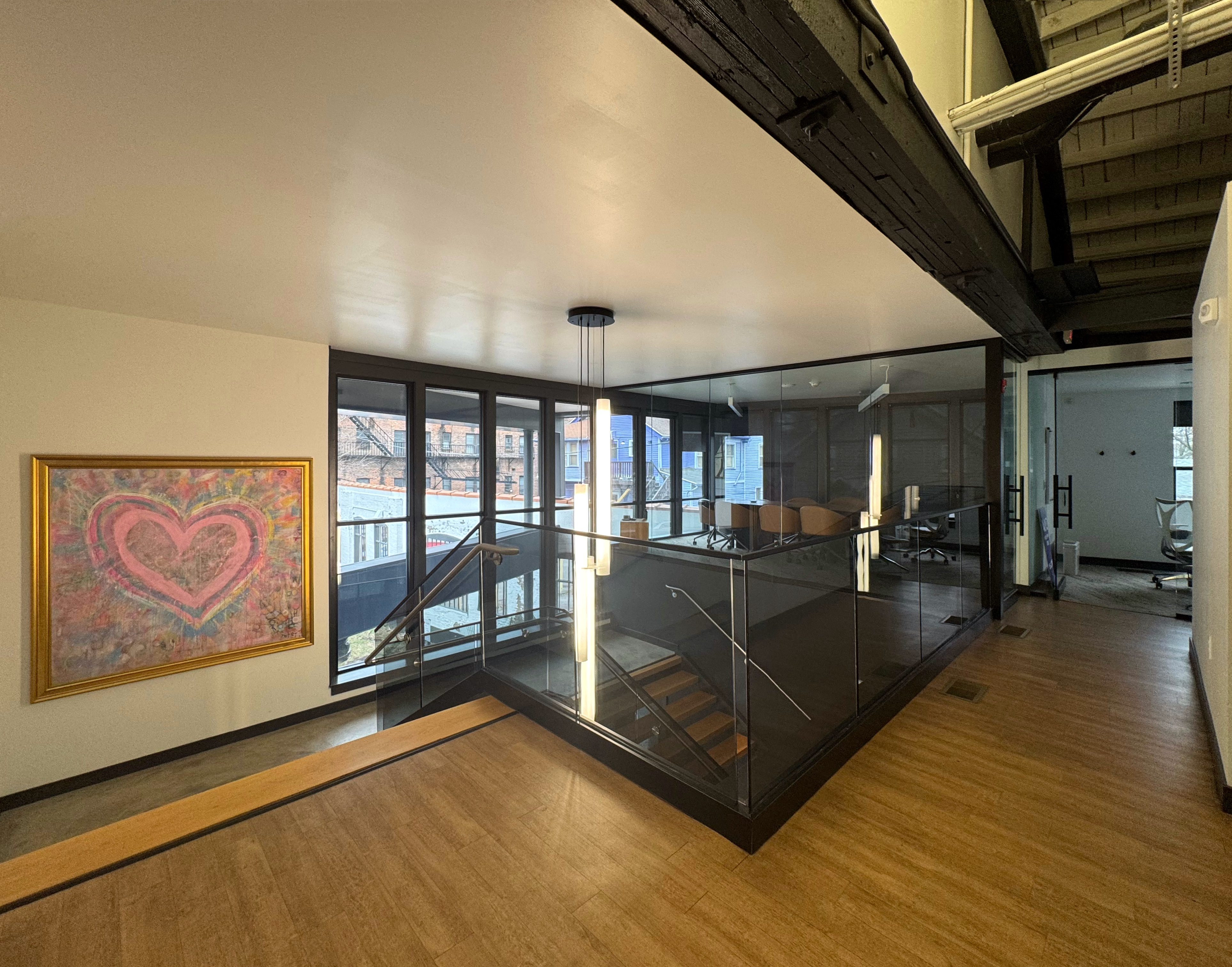 Open two story stair case in Career stark, with glass walls, and surrounded by windows