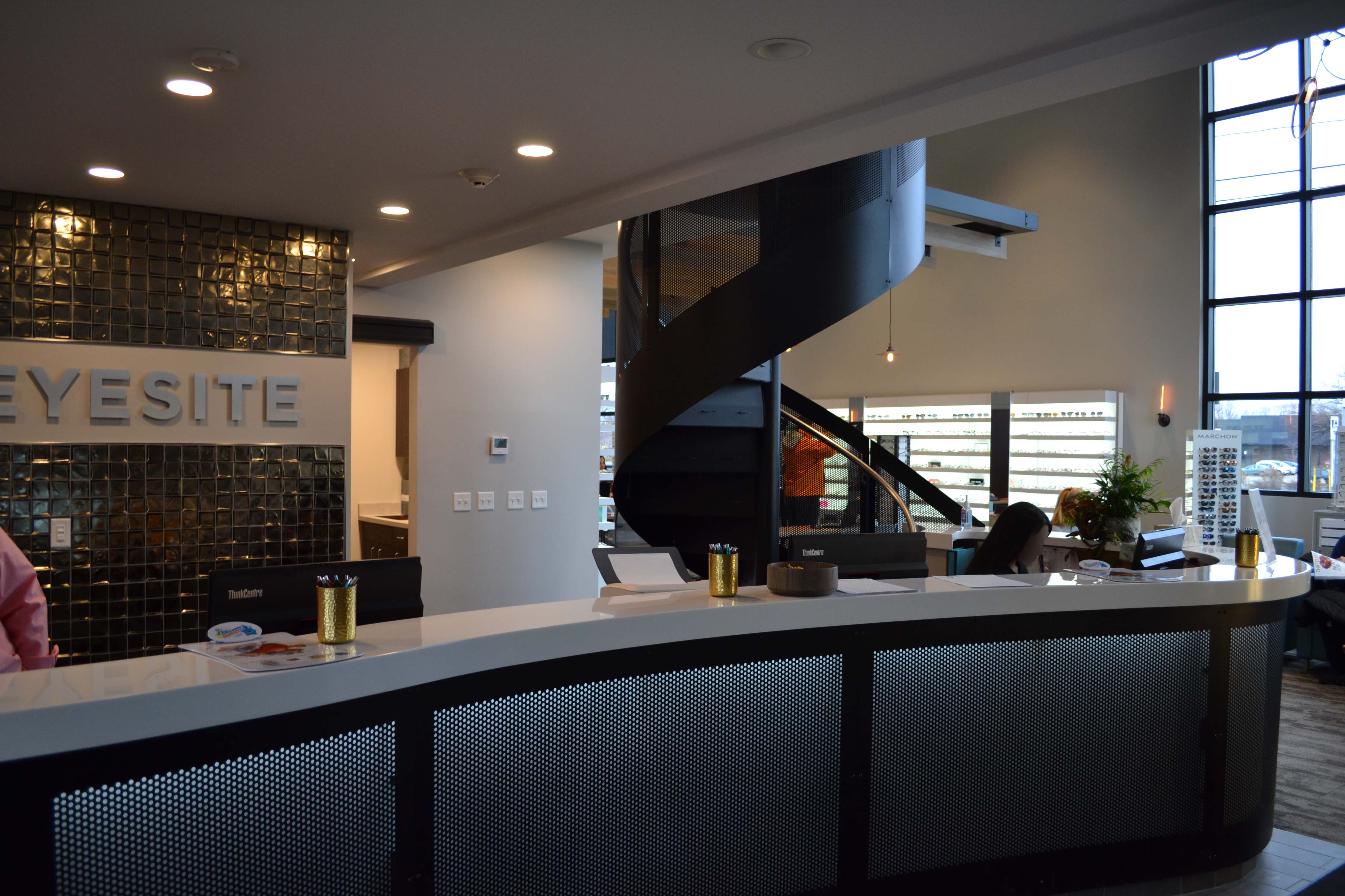 Front reception area of Eyesite optometry, with staircase to offices in view