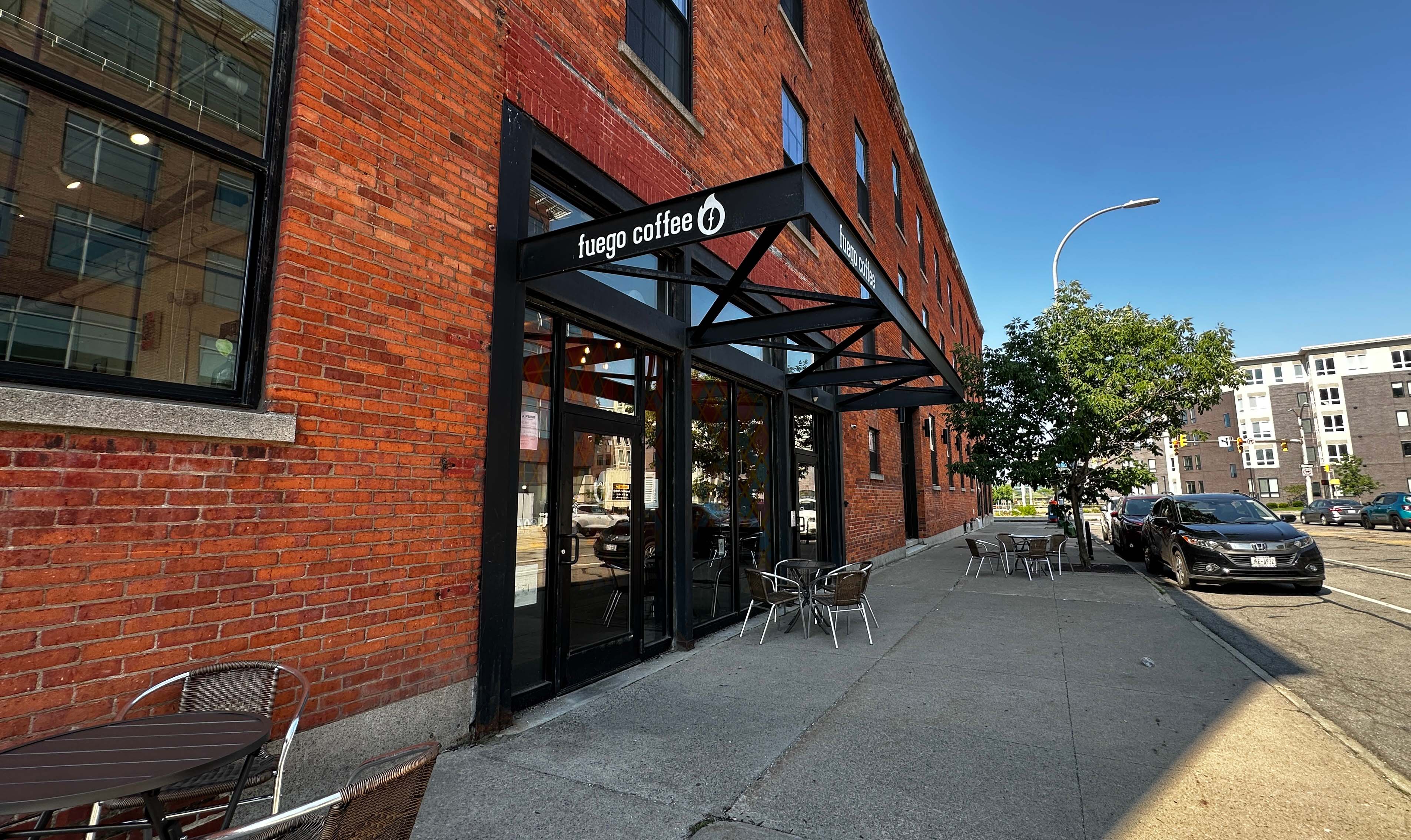 Exterior of Woodbury commercial tenant Fuego, showing cantilevered sign and brick facade