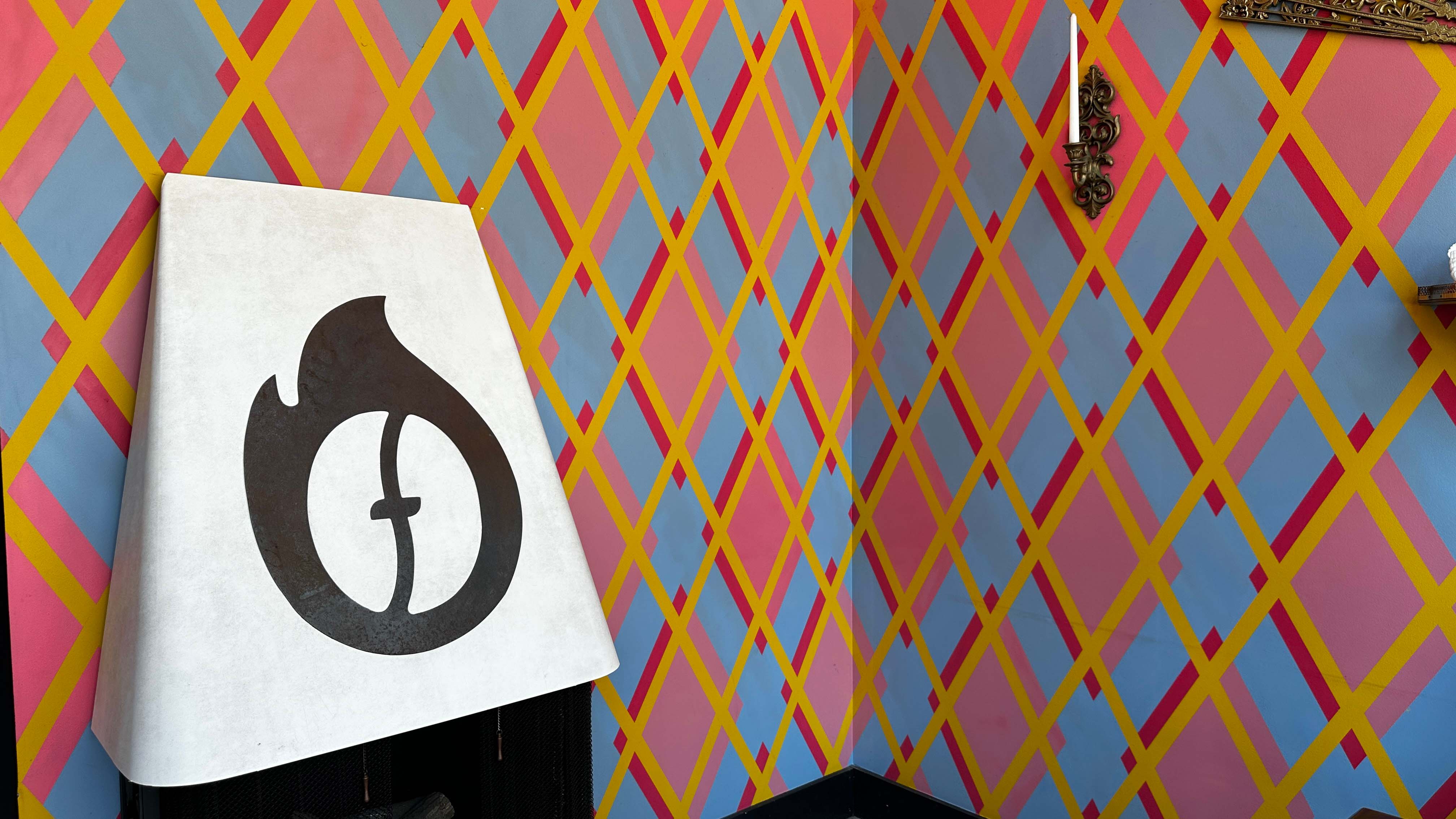 Walk in to Fuego, colorful checkered wall paper, branded fireplace