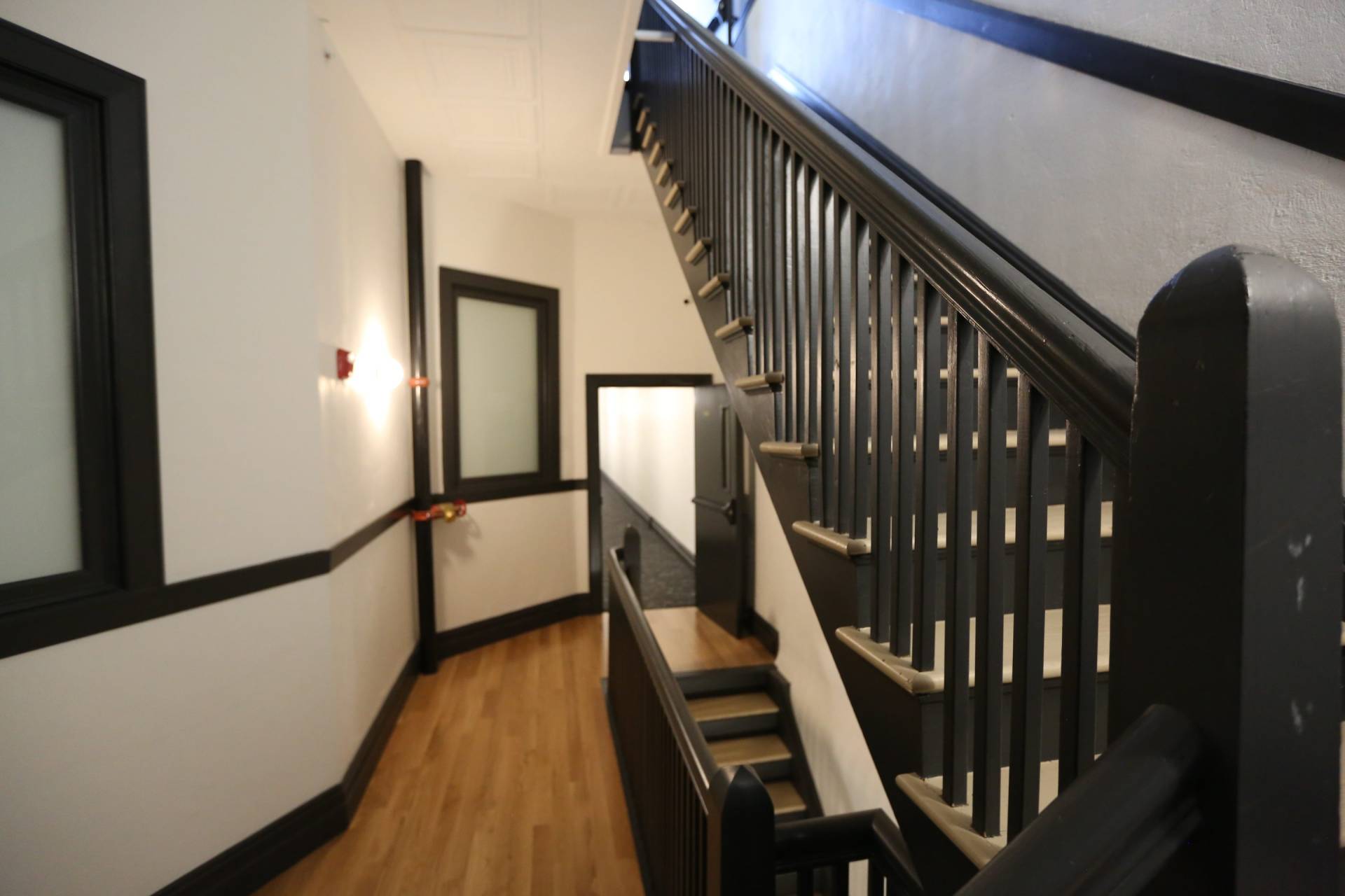 Stairwell of Glenny building, black railing, white walls