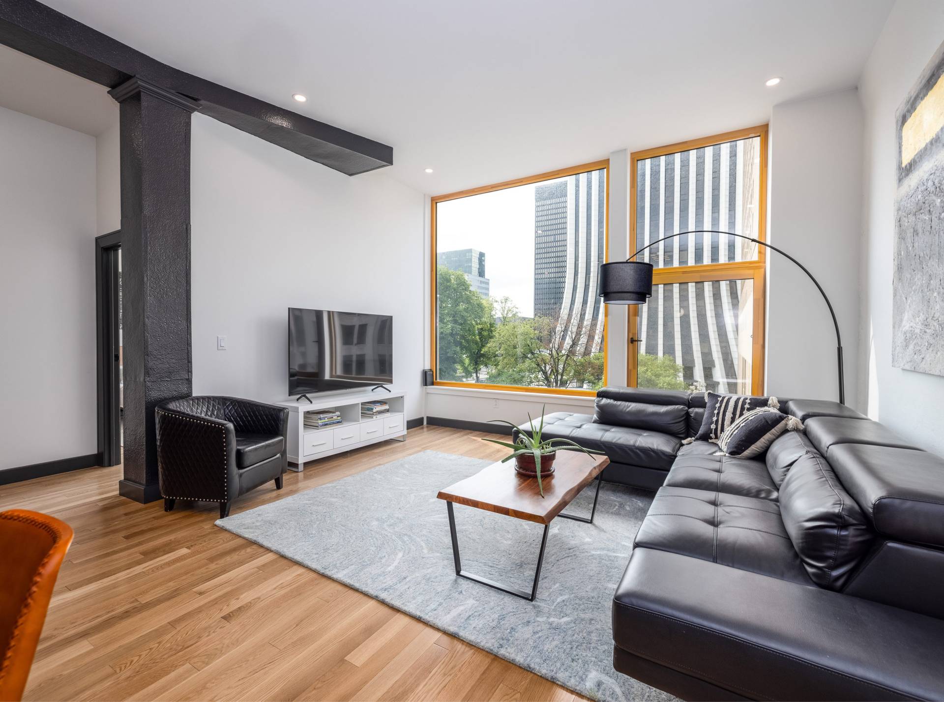 Interior of Glenny unit with massive  10x10 window facing metropolitan building